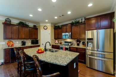 Gourmet kitchen with huge center island, and stainless steel appliances.