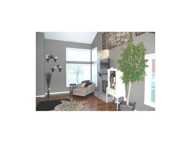 The living room features wonderful windows and a c