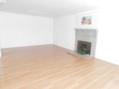 Unfurnished living room featuring crown molding, light wood finished floors, and a tiled fireplace