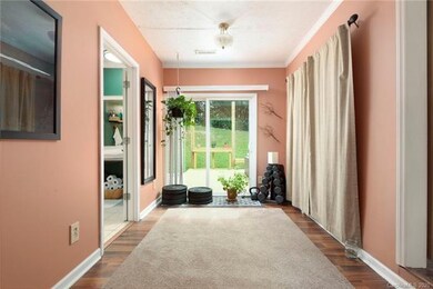 Main bedroom flex area with access to the bedroom, full bath, and sliders to the back deck.