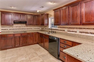 Ceramic tile details line the kitchens backsplash 