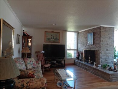 A Stone wood burning fireplace is in the Living Ro