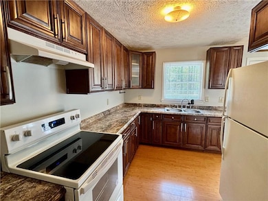 Kitchen featuring a sink, light wood-type flooring