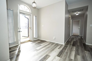 Foyer entrance featuring wood finished floors, vis