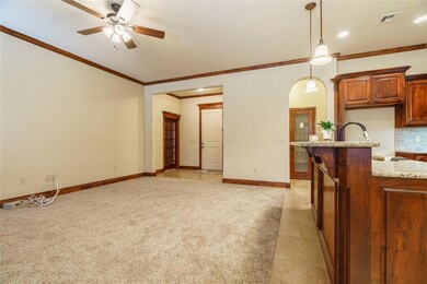 Kitchen featuring ceiling fan, hanging light fixtu