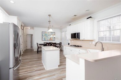 Kitchen with visible vents, crown molding, a sink,