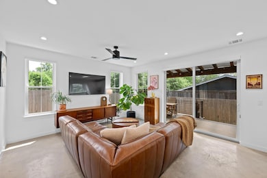 Living area with concrete flooring, visible vents