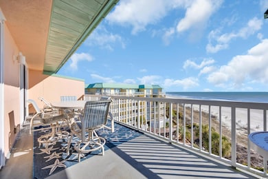 Balcony with a view of the beach and a water view
