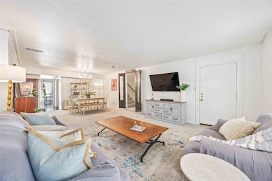 Open-concept flow from living to formal dining, ideal for seamless entertaining.