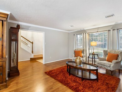 Gather the family and guests together in your lovely living room! It features a laminate hardwood floor, crown molding, and large windows with privacy blinds, and they also provide plenty of natural light throughout the day.