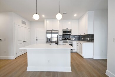 Kitchen with stainless steel appliances, baseboar