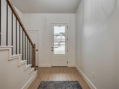 View of front of house featuring brick siding, a front lawn, and roof with shingles
