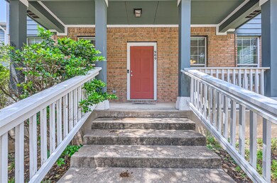 View of exterior entry featuring a porch and bric