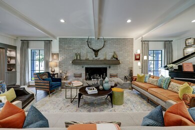 A stunning mid-century brick fireplace takes cente