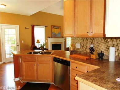 Kitchen. More laminate flooring, glass tile back splash and stainless appliances makes this ktichen complete.