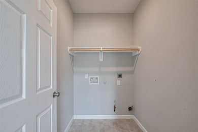 This photo shows a laundry room with hookups for a