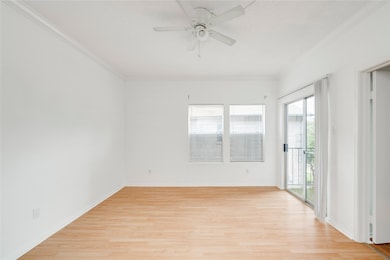 Unfurnished room featuring baseboards, light wood
