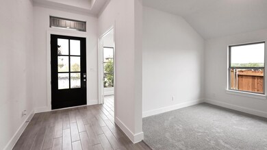 Foyer entrance featuring baseboards, lofted ceili