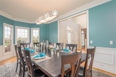 Formal dining room with view into the 2 story foye