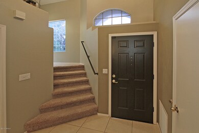Front Door of Home W/ Angled Stairway