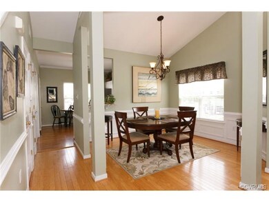 Formal dining with beautiful hardwood floors, vaul