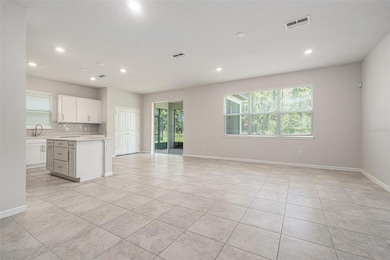 Living area looking to kitchen/dining