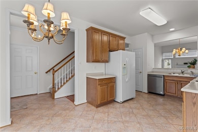 Kitchen featuring a chandelier, stainless steel di