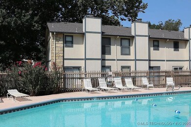 Community pool featuring fence and a patio area