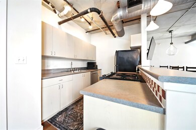 The kitchen that overlooks the living room and bre