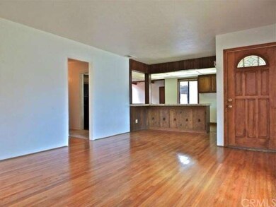 Entry and living room with views into the kitchen 