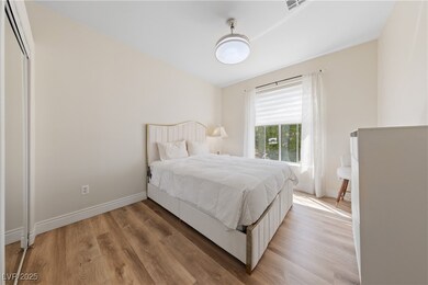Bedroom featuring light wood-style floors and base