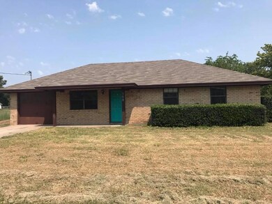 Ranch-style house featuring a front yard