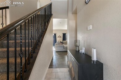 Stairway with tile floors and a high ceiling