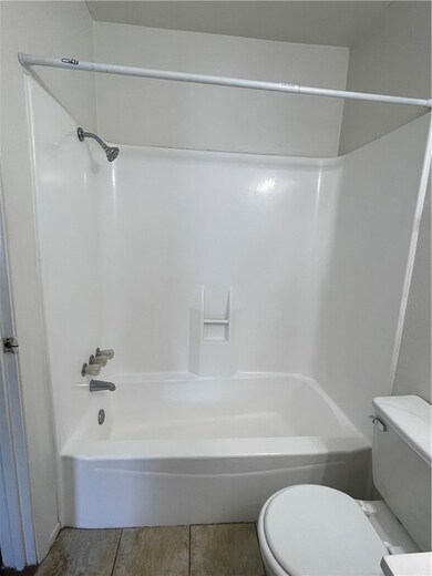 Bathroom with tub / shower combination and toilet