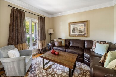 Hardwood floored living room with ornamental moldi