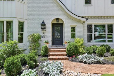 Property entrance with brick siding and board and 