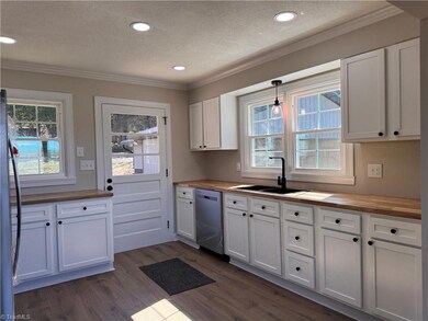 Lovely open kitchen with lots of natural light. Butcher block countertops, SS brand new appliances