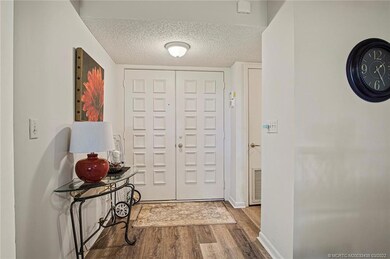 Inside entrance to condo with double doors