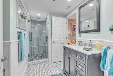 Bathroom featuring walk in shower, tile patterned 