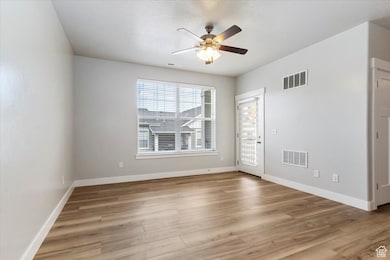 Spare room featuring a ceiling fan and light wood finished floors