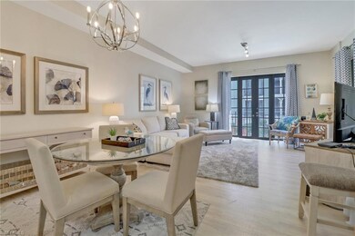 Dining room featuring light hardwood / wood-style floors, french doors, and a chandelier