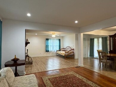 Living room featuring ornate columns, hardwood / w