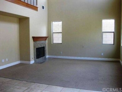Family room with fireplace and overhead loft