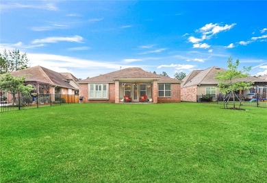 Covered patio overlooking rear yard and pond