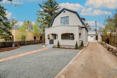 View of front of property with an outbuilding, stu