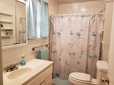 The nice sized bathroom has a tub/shower combo and