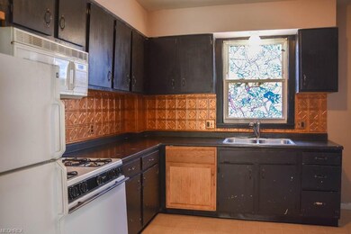 Kitchen has tin backsplash.