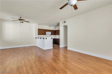Unfurnished living room with arched walkways, a ce