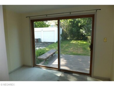 Off the dining room, a pair of louvered doors lead