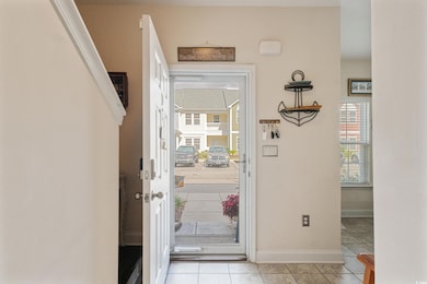 Entryway featuring baseboards and light tile patterned flooring